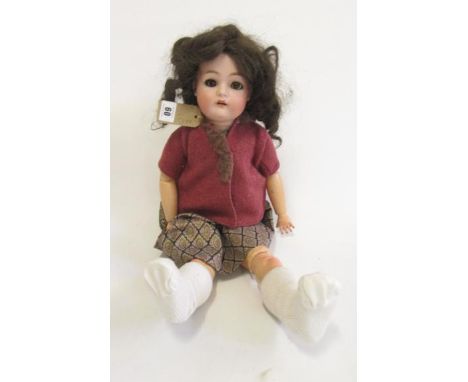 A Kammer &amp; Rheinhardt bisque head doll with brown glass sleeping eyes, open mouth and teeth, pierced ears, brown mohair w