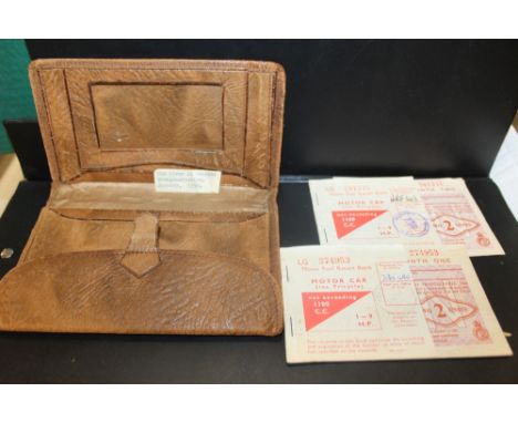A VINTAGE LEATHER PURSE CONTAINING MOTOR CAR FUEL VOUCHERS
