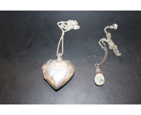 A LARGE STERLING SILVER HEART SHAPED LOCKET ON CHAIN TOGETHER WITH A SILVER AND OPAL PENDANT ON CHAIN