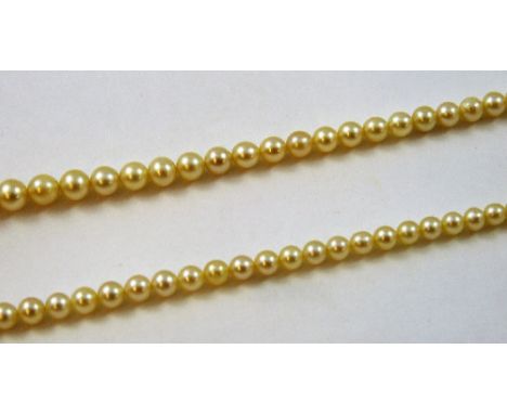 A graduated single row cultured pearl necklace, to a synthetic ruby and diamond set clasp.