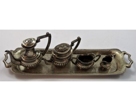 A silver miniature tea and coffee service, London 1974, comprising tea pot, coffee pot, sugar bowl, milk jug and two handled 