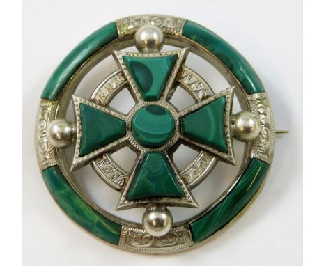 A Victorian Celtic silver and malachite brooch, of circular openwork form the engraved frame in the form of a Celtic cross wi