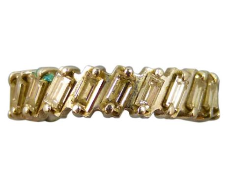 A white metal set diamond eternity ring, claw set with twenty two baguette diamonds of approximately 0.15cts each, total weig