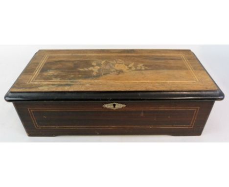 A 19th century Swiss musical box, playing eight airs with a 43 tooth single piece comb, the rosewood and simulated rosewood c