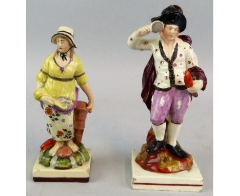 A late 18th/ early 19th century pearlware figure of a fishwoman, standing wearing a bonnet and cradling fish in her apron, on
