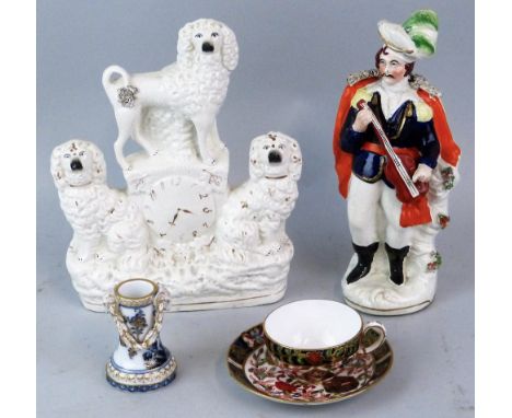 A Victorian Staffordshire flat-back group of three dogs around a clock face, 24cm high, a Staffordshire figure of a man in mi