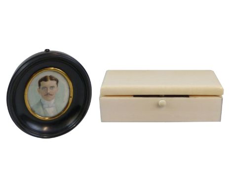 An early 20th century miniature on ivory, oval head and shoulder portrait of a man, in ebonised frame, 5cm x 4cm and an ivory