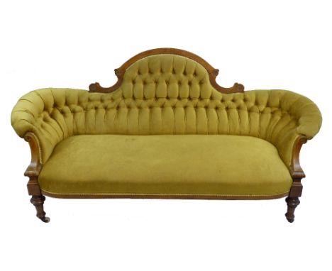 A Victorian inlaid walnut settee, the arched scrolling back with later deep buttoned upholstery and curving ends, inlaid and 