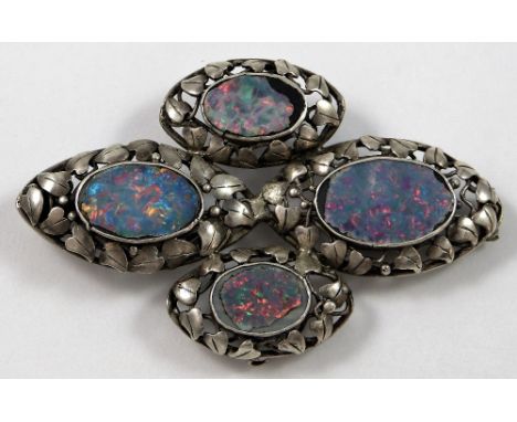 An Arts & Crafts silver and black opal brooch, probably Birmingham School of Arts, circa 1900, composed of four panels border