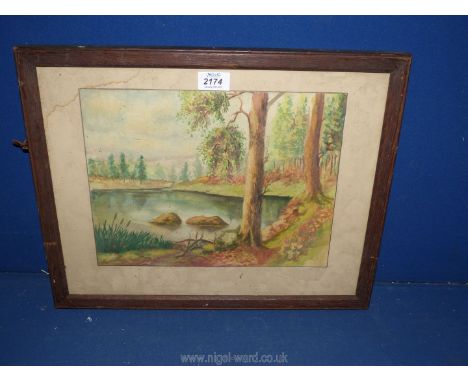 A framed Watercolour of a landscape signed lower right C.W. Squires and backed with a Wotan Lamp advert, a/f.