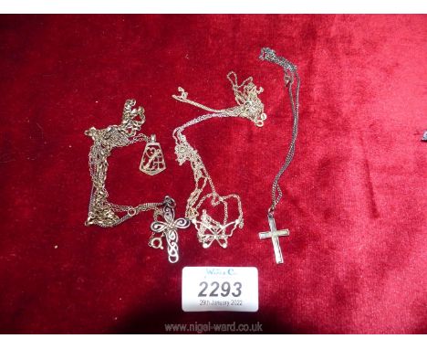 A collection of Silver 925 necklaces a butterfly, two crosses, and a sweetheart pendant and chain.