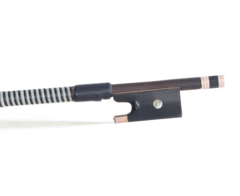 Gold mounted violin bow, unstamped, the stick octagonal, the ebony frog inlaid with pearl eyes and the ebony adjuster with tw