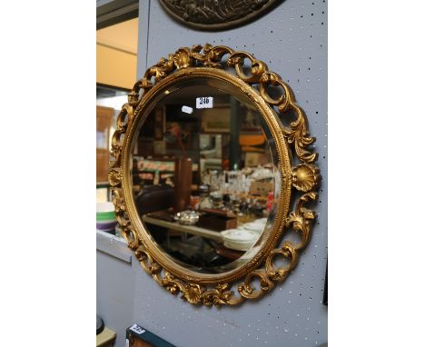Good quality Bevel edge circular mirror with foliate and shell gilded surround 