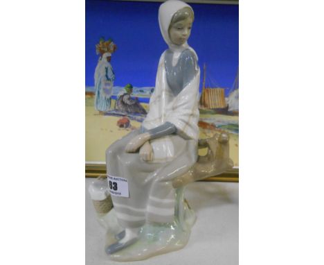 A Lladro Figure of a Girl on a Seat.