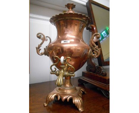 A 19th Century Brass Mounted Copper Samovar with Ceramic Handles, the lid marked 'Warranted Best London Manufacturers'.