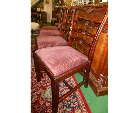 A Set of Six Mahogany Ladder Back Dining Chairs having drop-in seats upholstered in burgundy fabric, four standards and two c