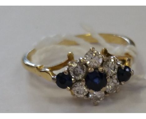 An 18ct Gold  Diamond & Sapphire Cluster Ring.