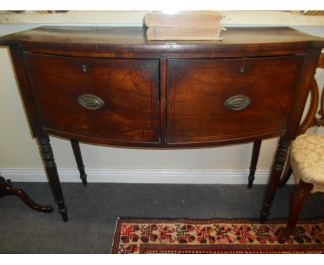 A Very Early 19th Century Mahogany Bow Front Side Table, of narrow proportions. with twin cupboard doors on ring turned legs.