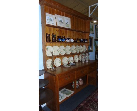 An Impressive Large Pine Kitchen Dresser, with plank back top above a base of three freize drawers and open platform shelf, 2