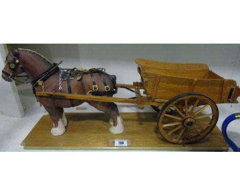 A Beswick Model of a Shire Horse Mounted with a Scale Model of a Hay Cart; on a wooden plinth. 60 cm long.