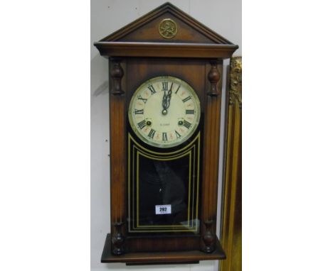 A Wall Clock with Simulated Column Supports; with a 31 day striking movement beneath an architectural frieze.