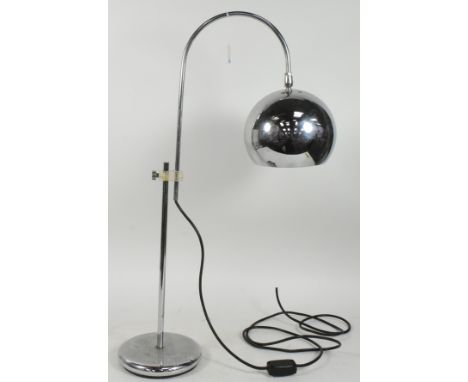 A 20th century mid century industrial style chrome metal table lamp having cantilever shade over circular base. Measures appr
