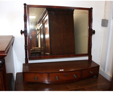 A Georgian mahogany swing toilet mirror, the rectangular plate mounted on leaf carved turned columns above a three drawer bow