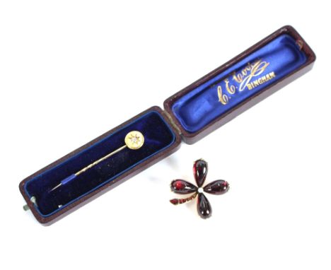 A diamond mounted gold stick pin, in original box; together with a gold and garnet brooch