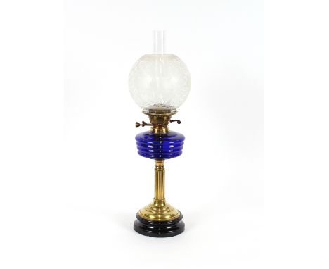 A Victorian brass Corinthian&nbsp;column table oil lamp, with blue glass reservoir and etched globular shade, 41cm high