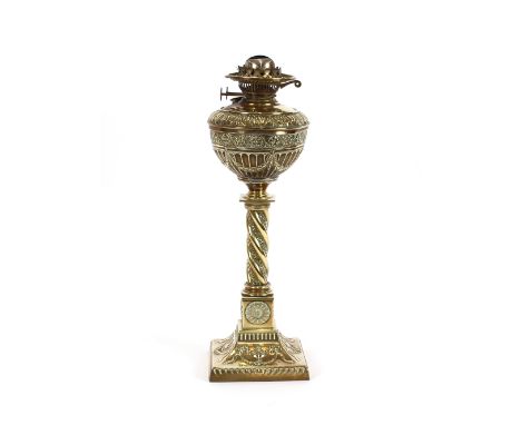 A 19th Century ornate brass table oil lamp, with raised foliate decoration and twist column, 50cm high