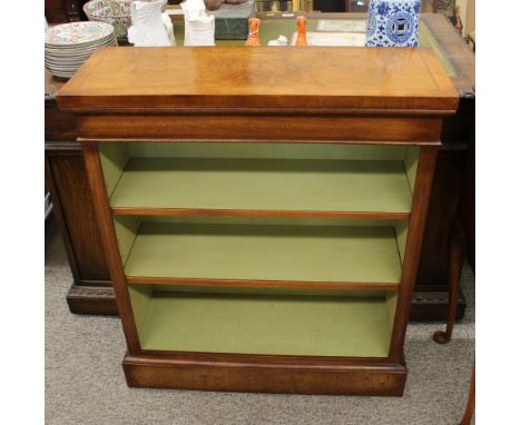 A walnut open fronted bookcase, with herringbone cross-banding, raised on a platform plinth, 76cm wide x 89cm high