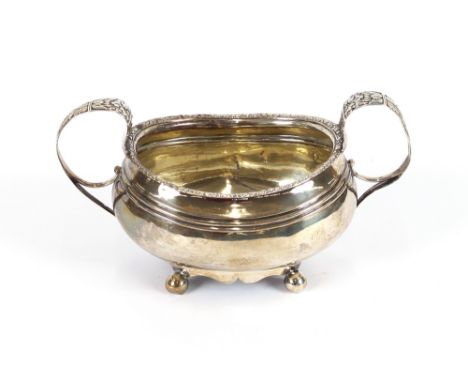 A George III silver sucrier, having foliate border decoration and gilded interior, raised on four ball feet, London date lett
