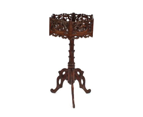 A carved mahogany plant stand, of octagonal form, pierced gallery decorated deer and flowers, raised on a rustic tripod base,