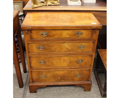 An 18th Century style walnut and herringbone cross-banded bachelor's chest, having fold-over top above four graduated drawers
