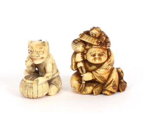 A small Japanese carved ivory Netsuke,&nbsp;in the form of a seated figure with attendant children; and another of a seated b
