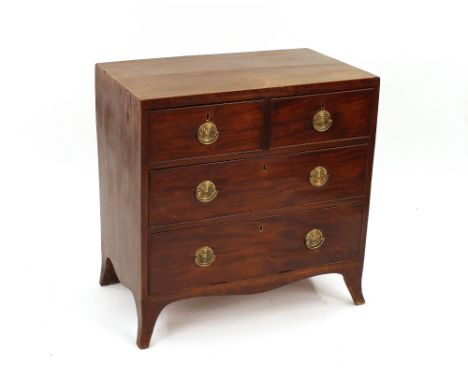 A George III mahogany and boxwood strung chest, of two short and two long drawers, raised on a shaped apron and bracket feet,