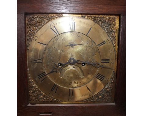 An 18th Century oak cottage long case clock, the stepped hood enclosing a brass spandril dial, inscribed "Wood of Grantham", 