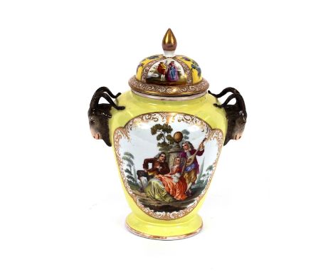 A Dresden porcelain baluster vase and cover, flanked by ram's head mask handles and decorated panels of flowers and figures i