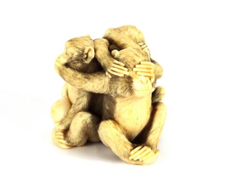 A carved Japanese ivory Netsuke, in the form of three entwined monkeys, 4.5cm high