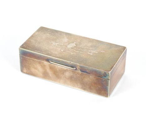 A silver presentation table cigarette box, Birmingham 1947, 18.5cm long; and a smaller cigarette box with presentation inscri