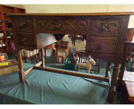An Oak Desk with Tooled Leather Top and Three Carved Drawers with Two Under 