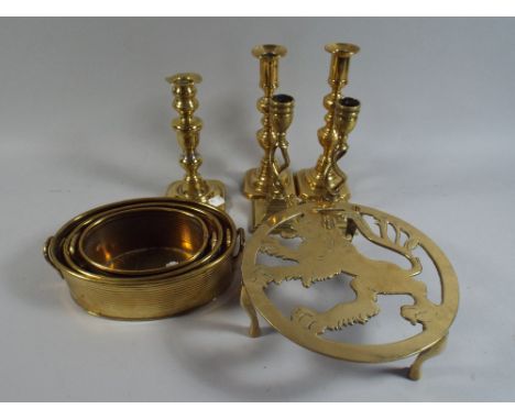 A Collection of Brass Ware to Include Two Pairs of Candle Sticks, One Lion Trivet, Three Graduated Oval Planter and A Single 