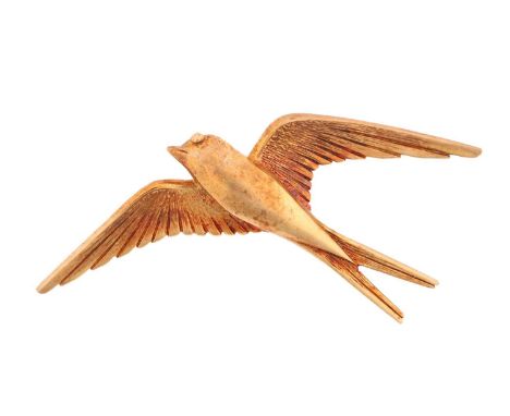 A brooch in the form of a flying swallow, fitted with pin stem and roll-over clasp, marked '375' and rubbed off British impor