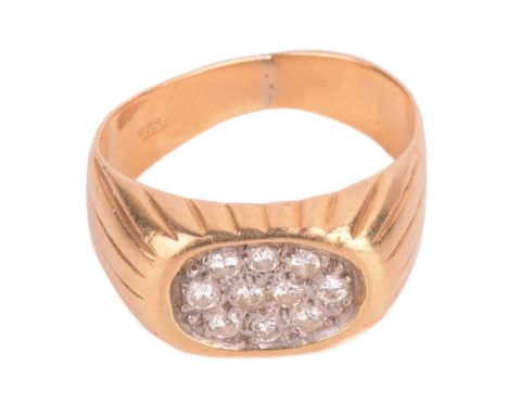 A diamond-set signet style ring, the oval ring head pavé-set with brilliant-cut diamonds, to reeded shoulders and tapered fla