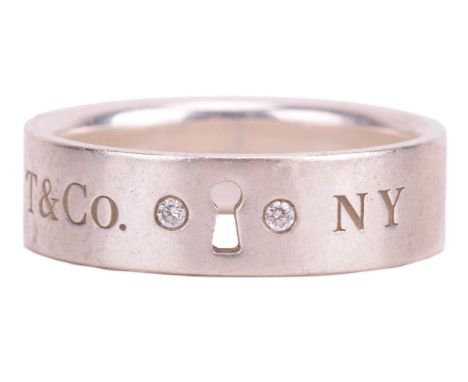 Tiffany &amp; Co. - a keyhole ring set with diamonds, centred with a pierced-out keyhole motif flanked by two diamond highlig
