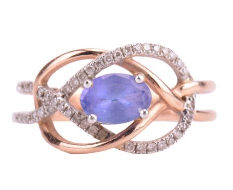 A tanzanite and diamond dress ring in a knot design, centred with an oval-cut tanzanite of pale bluish-purple, within an open