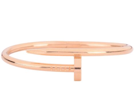 Cartier - a 'Juste un Clou' hinged bracelet in 18ct yellow gold, classic model, of a bent nail motif, signed and numbered, Sw