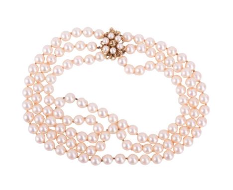 A three-row cultured pearl necklace with floral clasp, comprising three strands of round cultured pearls of 7.0 - 7.3 mm, cre
