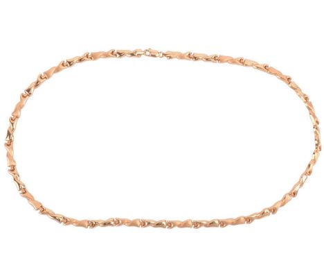 A fancy link necklace comprising a chain of hinged and hollow links of twisted form, alternating with polished and brushed te
