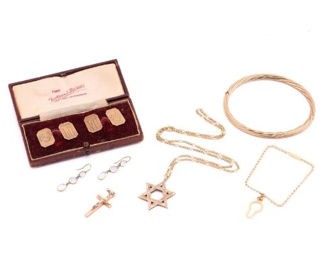 A small collection of 9ct yellow gold jewellery items; including a hinged bangle of twisted rope design, a Star of David pend